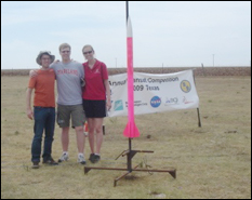 The Clark School's launch team (Kevin Davis, Dru Ellsberry, and Laura Meyer) with CanSat Payload loaded on rocket. 