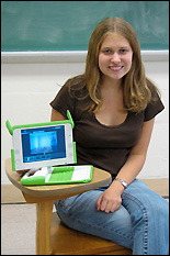 Mary Yanik with her OLPC XO laptop. The machine features a swiveling monitor, wireless networking, a keyboard sealed against dirt and moisture, a camera for still photo and video capture, a microphone and speaker, a touchpad, text-to-speech capability, USB ports, and a USB key designed to restore the system in the event of a crash. The XO is neither a Mac nor Windows PC, and is not currently commercially available, but can save files in common formats for use on other computers. Its custom user interface, which minimizes the use of text, runs on the Linux operating system. Its preloaded suite of software is open-source and a community of developers has formed to create additional applications. Below: Children using their laptops at the Lova Soa school. Photos courtesy of Mary Yanik.