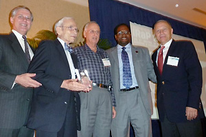 Professor Emeritus Joseph Silverman (second from left) is presented with IRaP's Lifetime Achievement Award by Clark School dean Darryll Pines (second from right) and MSE professor Mohamad Al-Sheikhly (far right).