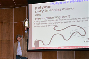 Professor Robert M. Briber demonstrating the molecular structure and relative size of a polymer molecule using his 