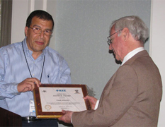 C. Frank Wheatley (right) was presented with the Pioneer Award from Mohamed Darwish, chairman of the IEEE convention, at the 23rd International Symposium on Power Semiconductor Devices & Ics on May 24, 2011, San Diego, Calif. Photo by Tom Wheatley.