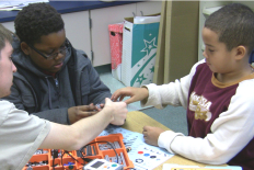 Scholars STS sophomores work with 4th grade students at Greenbelt Elementary School in the after school robotics club.