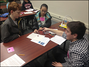 Clark School graduate students Colin Gore, Will Gibbons, Amy Marquardt and Chris Pellegrinelli taught a session of Adventure in Science, held at the National Institute of Standards in Technology, in which they showed kids how to make and test their own dye-sensitized solar cells. Above: Chris Pellegrinelli guides participants through the project. Photo courtesy of Colin Gore.