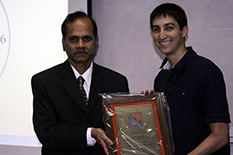 Eta Kappa Nu President Daniel Silversmith accepts the award from Department Chair Rama Chellappa.