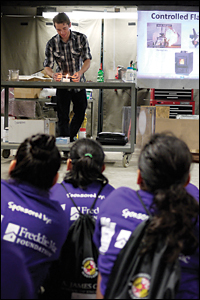 Ph.D. candidate Isaac Leventon explaining basic fire science to elementary school students from the America Reads*America Counts program.