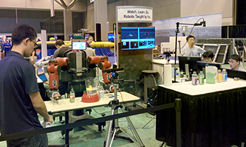 ARC Lab students with the Baxter robot salad-making demonstration at the DARPA Forum in St. Louis.