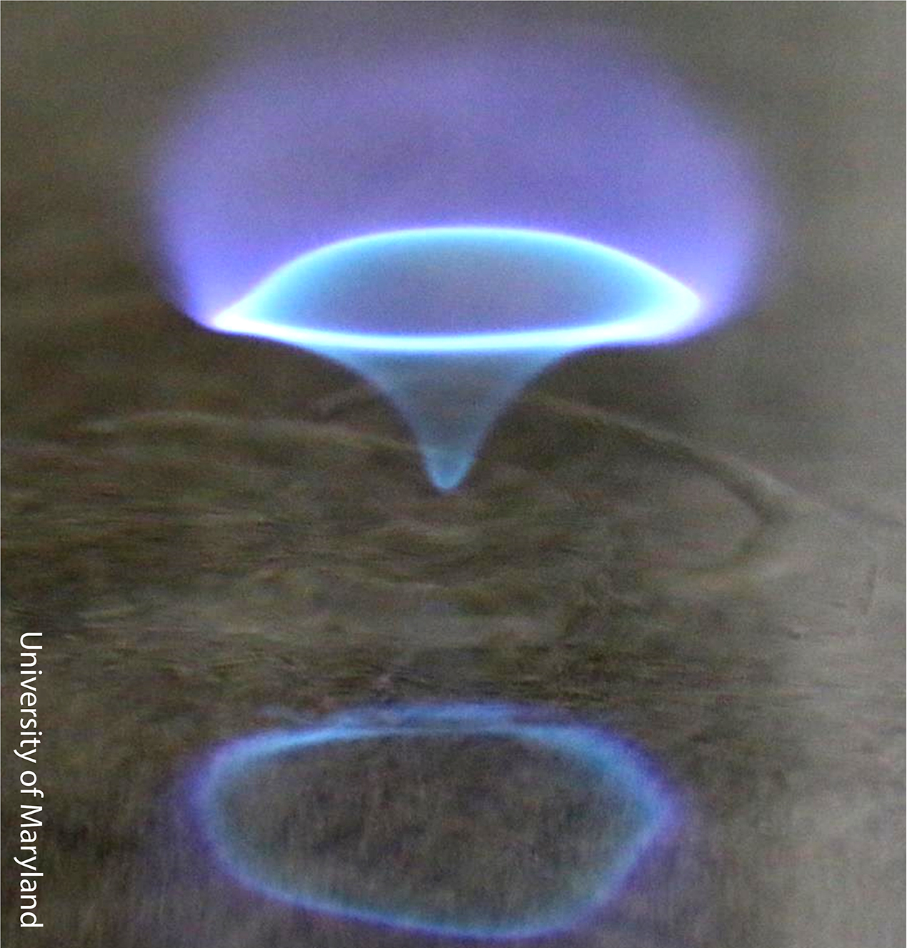 A blue whirl over water in a swirl generator. Photo: University of Maryland